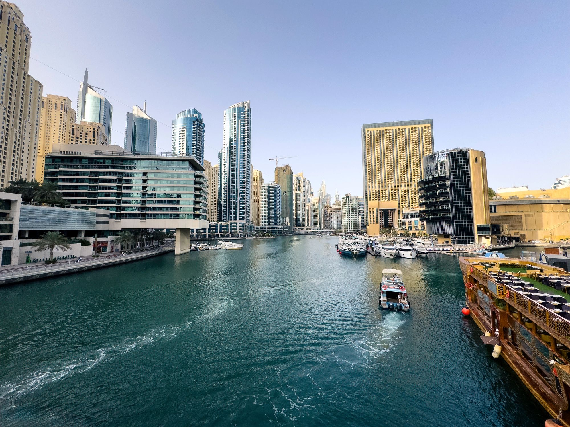 Dubai Marina waterfront with boats in the afternoon